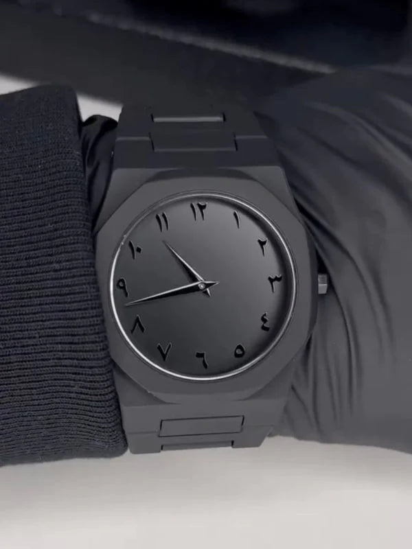 Black wristwatch on a plain background