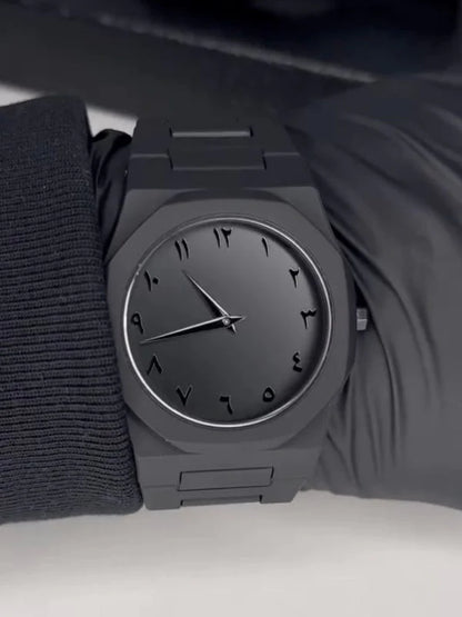 Black wristwatch on a plain background